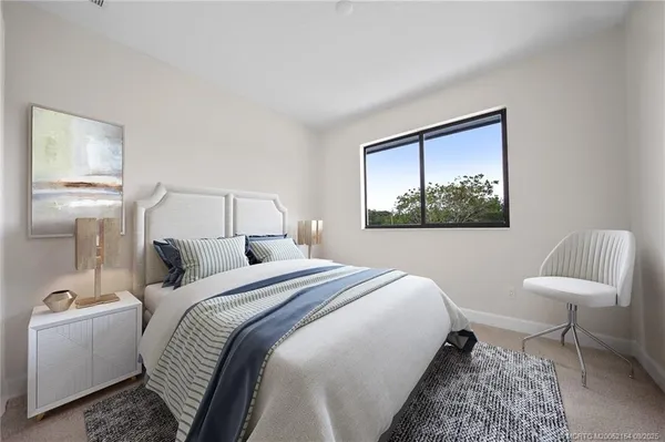 a bedroom with a bed and a chair