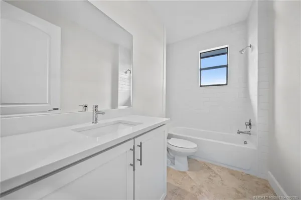 a bathroom with a granite countertop sink a toilet and a bathtub