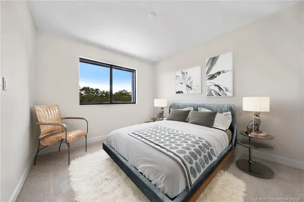 a bedroom with a bed and a painting on the wall