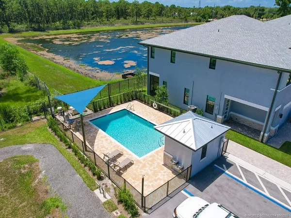an aerial view of a house with a yard and lake view