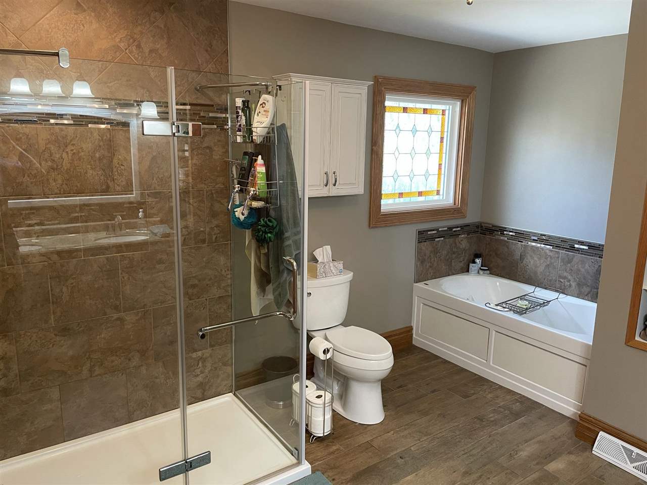 9474 Marengo Road Garden Prairie, IL 61038 - Photo 16 of 31 a bathroom with a toilet a sink and shower