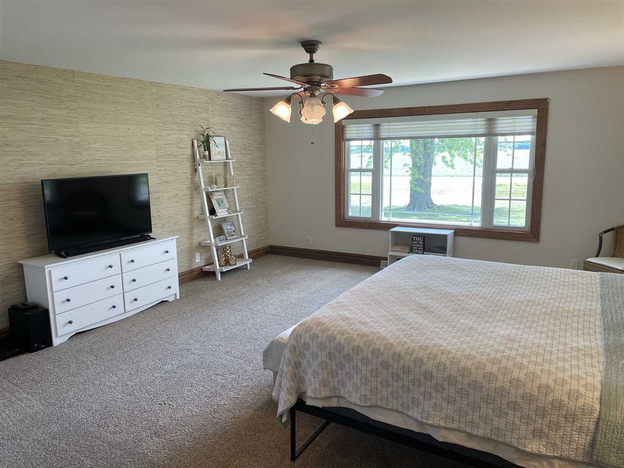 9474 Marengo Road Garden Prairie, IL 61038 - Photo 19 of 31 a bedroom with a bed and a flat screen tv