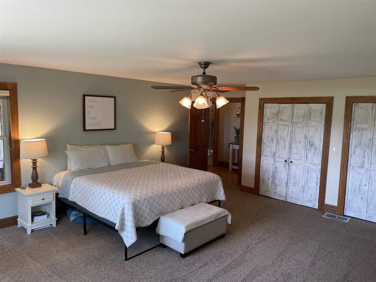 9474 Marengo Road Garden Prairie, IL 61038 - Photo 20 of 31 a spacious bedroom with a bed and a chandelier