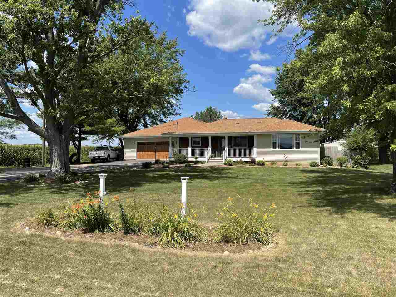 9474 Marengo Road Garden Prairie, IL 61038 - Photo 2 of 31 a front view of a house with a yard table and chairs