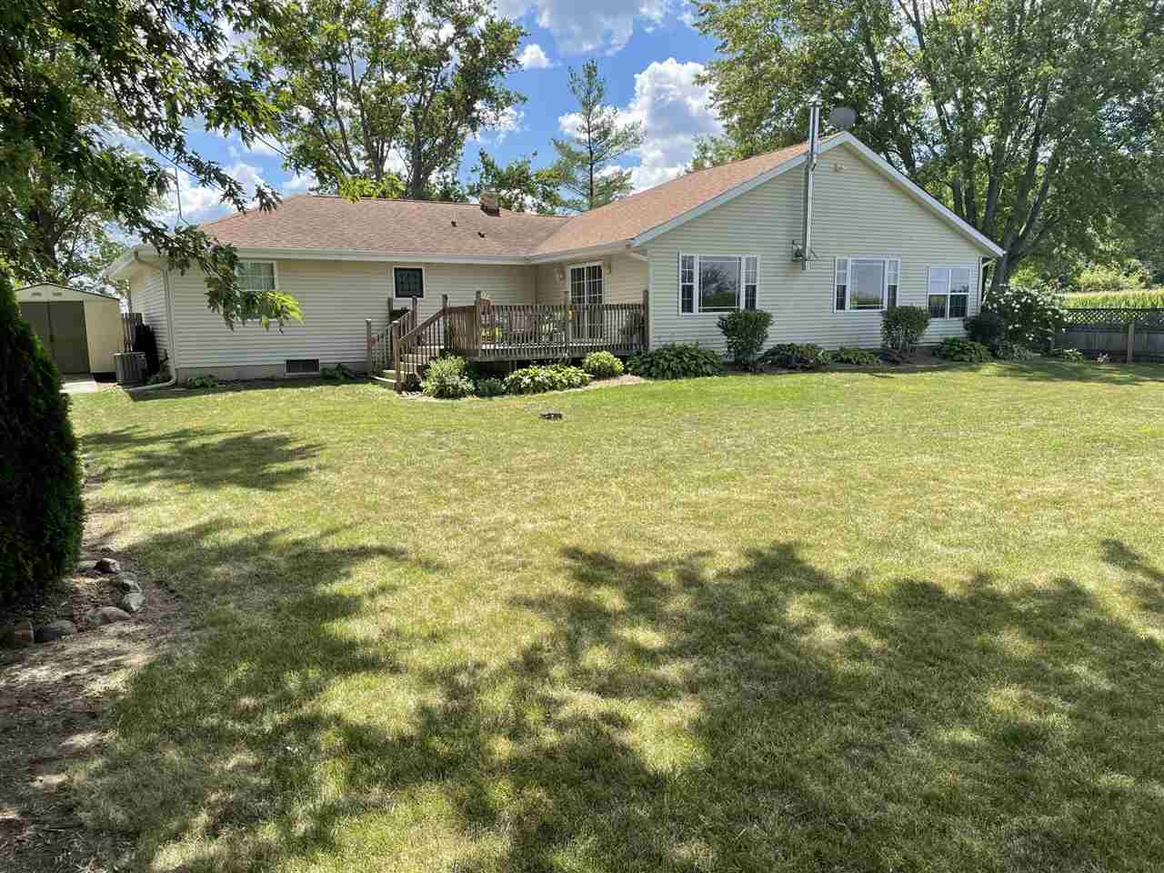 9474 Marengo Road Garden Prairie, IL 61038 - Photo 26 of 31 a view of a white house with a yard plants and large tree