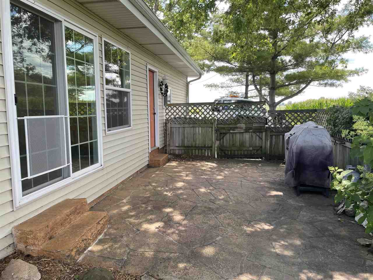 9474 Marengo Road Garden Prairie, IL 61038 - Photo 30 of 31 a view of a house with a yard and floor to ceiling window