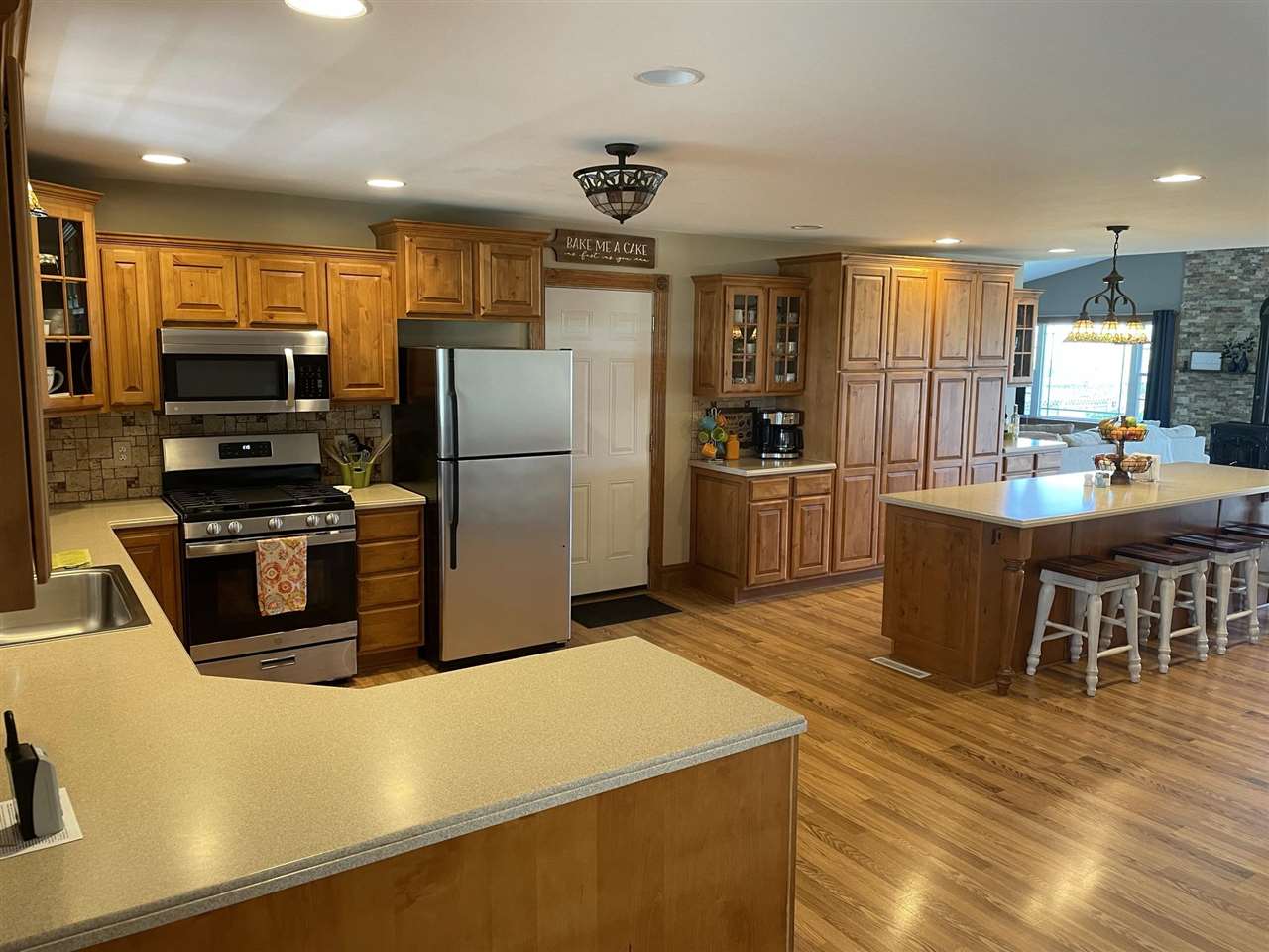 9474 Marengo Road Garden Prairie, IL 61038 - Photo 6 of 31 a kitchen with stainless steel appliances a stove a refrigerator a sink a dining table and chairs
