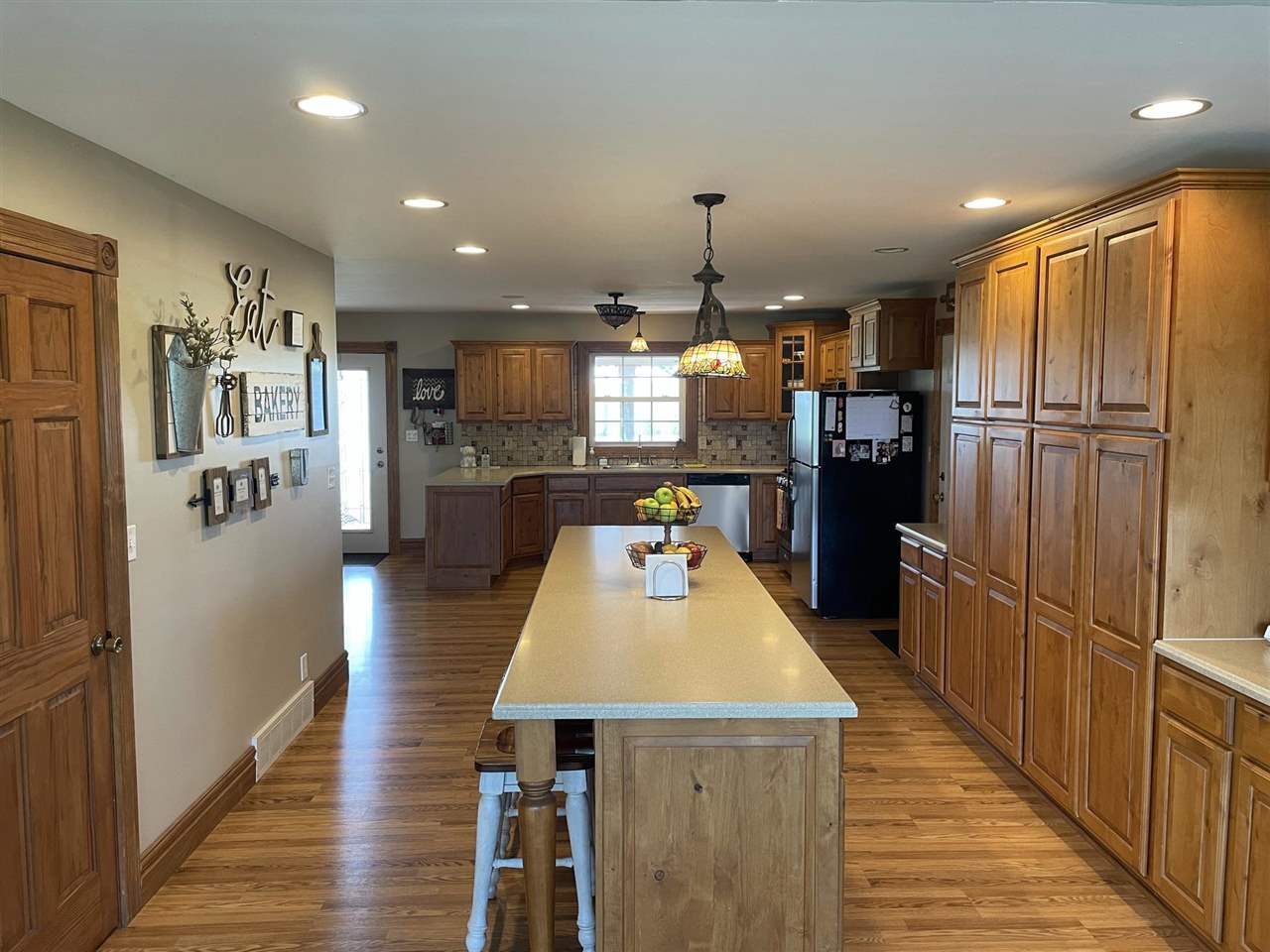 9474 Marengo Road Garden Prairie, IL 61038 - Photo 9 of 31 a kitchen with stainless steel appliances a refrigerator and a wooden cabinets