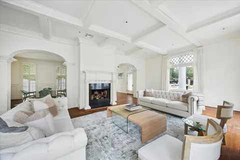 a living room with furniture a fireplace and a large window
