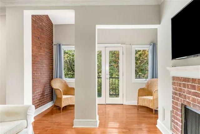 a living room with furniture a flat screen tv and a fireplace