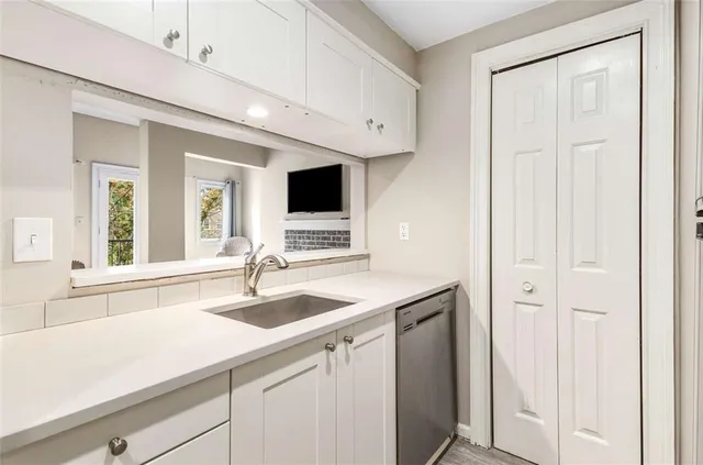 a kitchen with a sink and a mirror