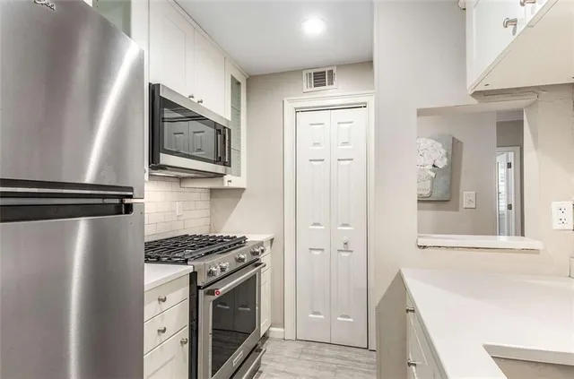 a kitchen with a refrigerator stove and sink