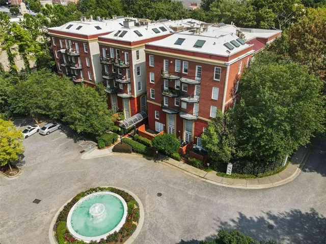 a view of a house with a yard and potted plants