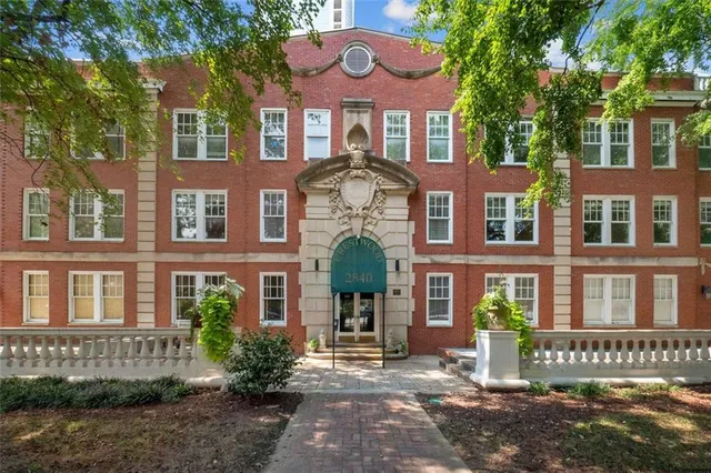 a front view of a building with garden