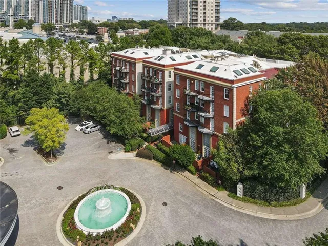 an aerial view of a house with a garden and lake view