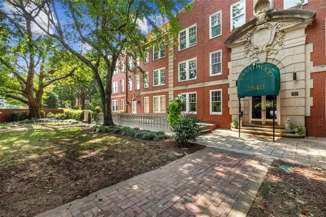 a view of a brick building next to a yard