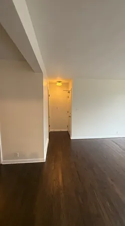 an empty room with wooden floor