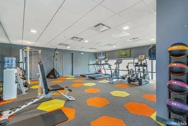 a room with gym equipment and view of living room