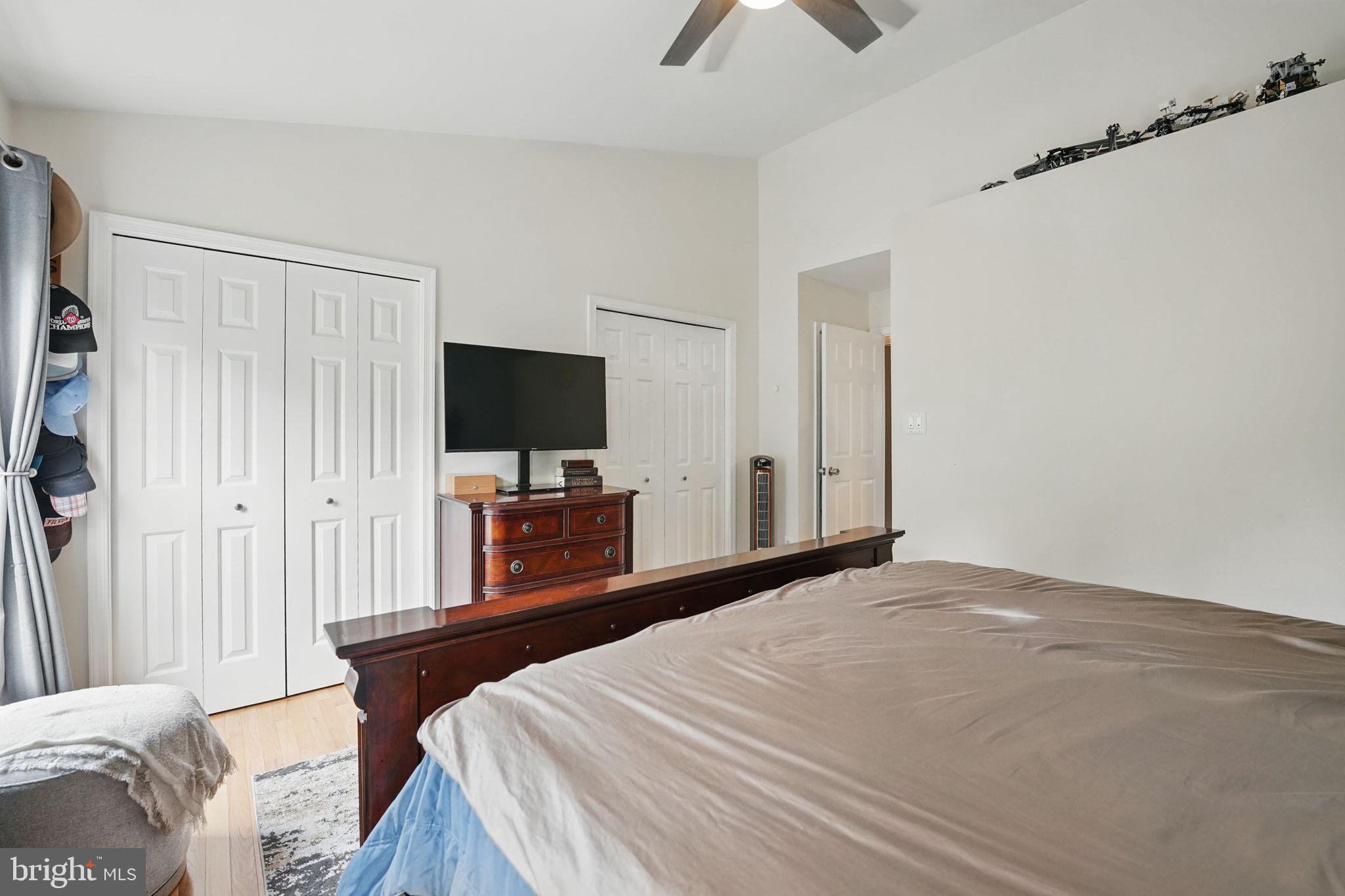 6383 Michael Robert Drive Springfield, VA 22150 - Photo 13 of 29 a bedroom with a bed and a flat tv screen on wall