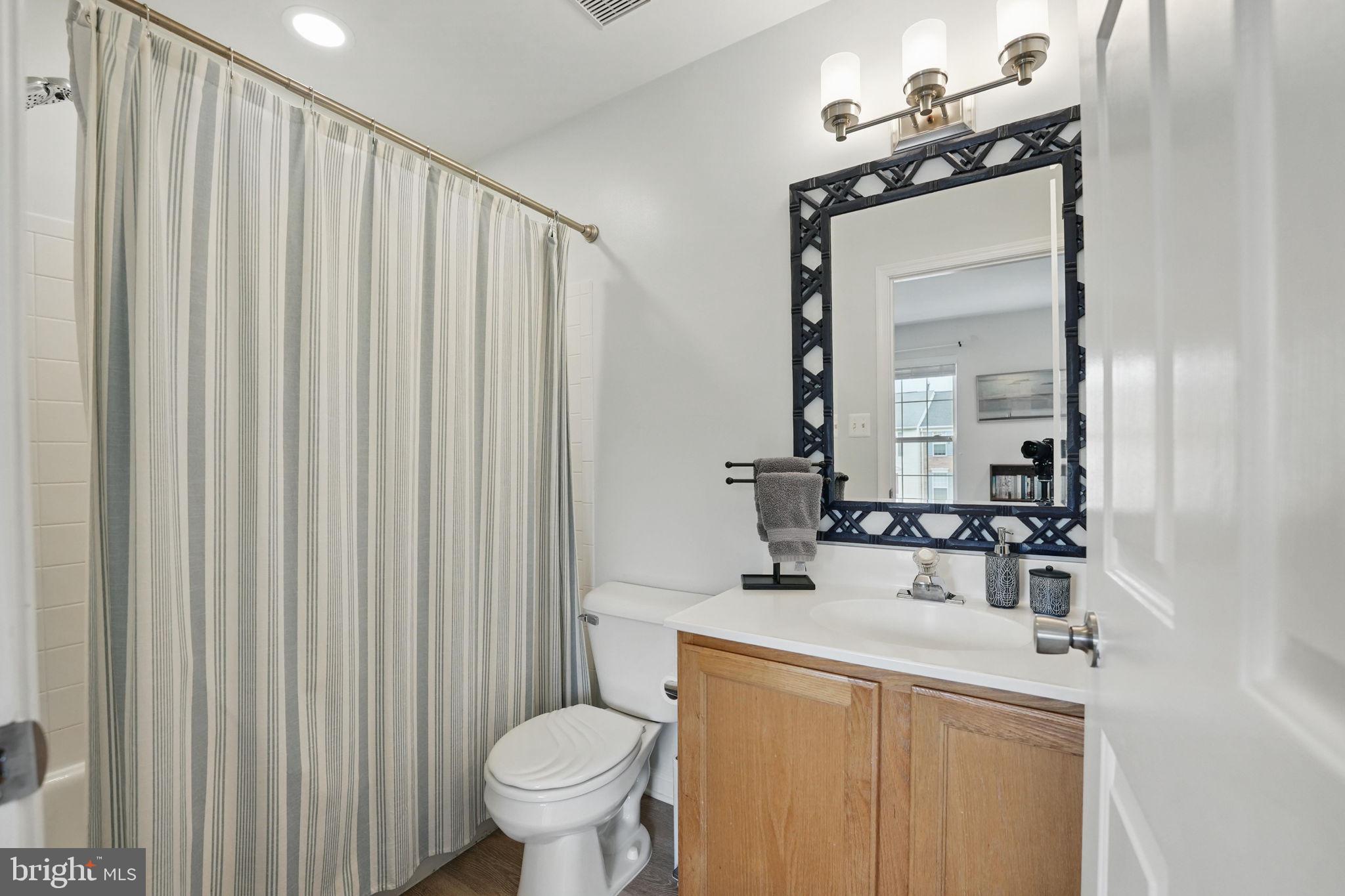 6383 Michael Robert Drive Springfield, VA 22150 - Photo 17 of 29 a bathroom with a sink a toilet and mirror