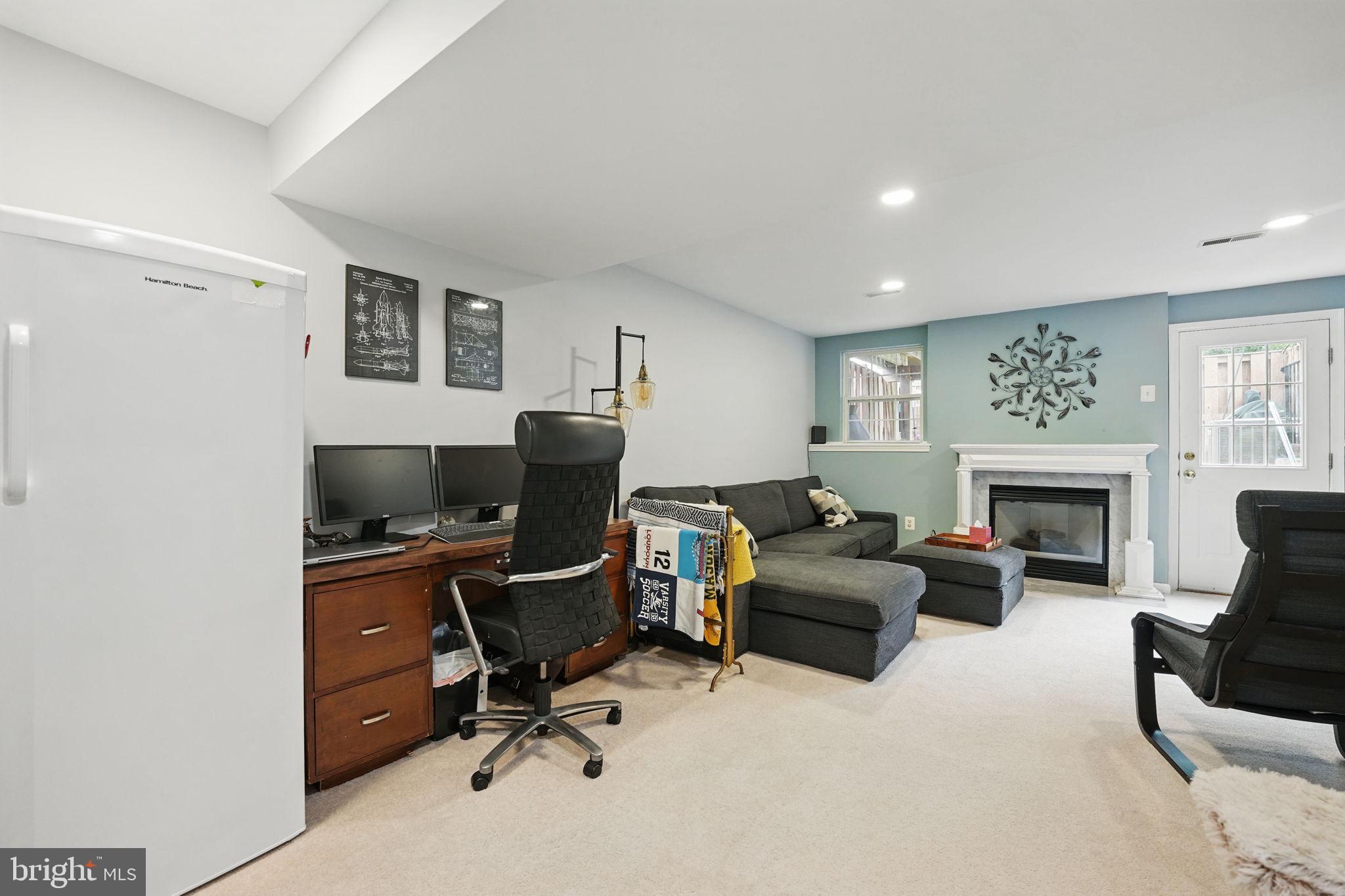 6383 Michael Robert Drive Springfield, VA 22150 - Photo 21 of 29 a livingroom with workspace fireplace and a couch