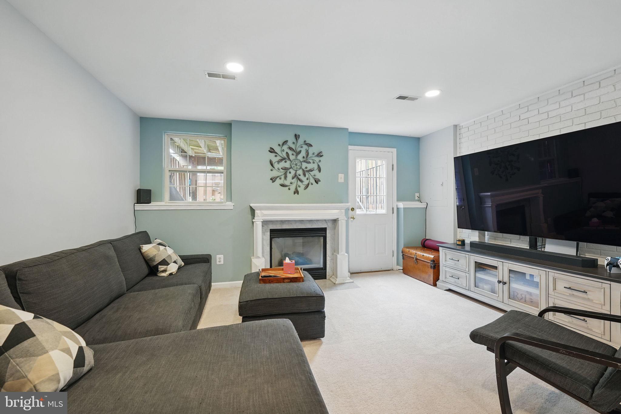 6383 Michael Robert Drive Springfield, VA 22150 - Photo 22 of 29 a living room with furniture and a flat screen tv