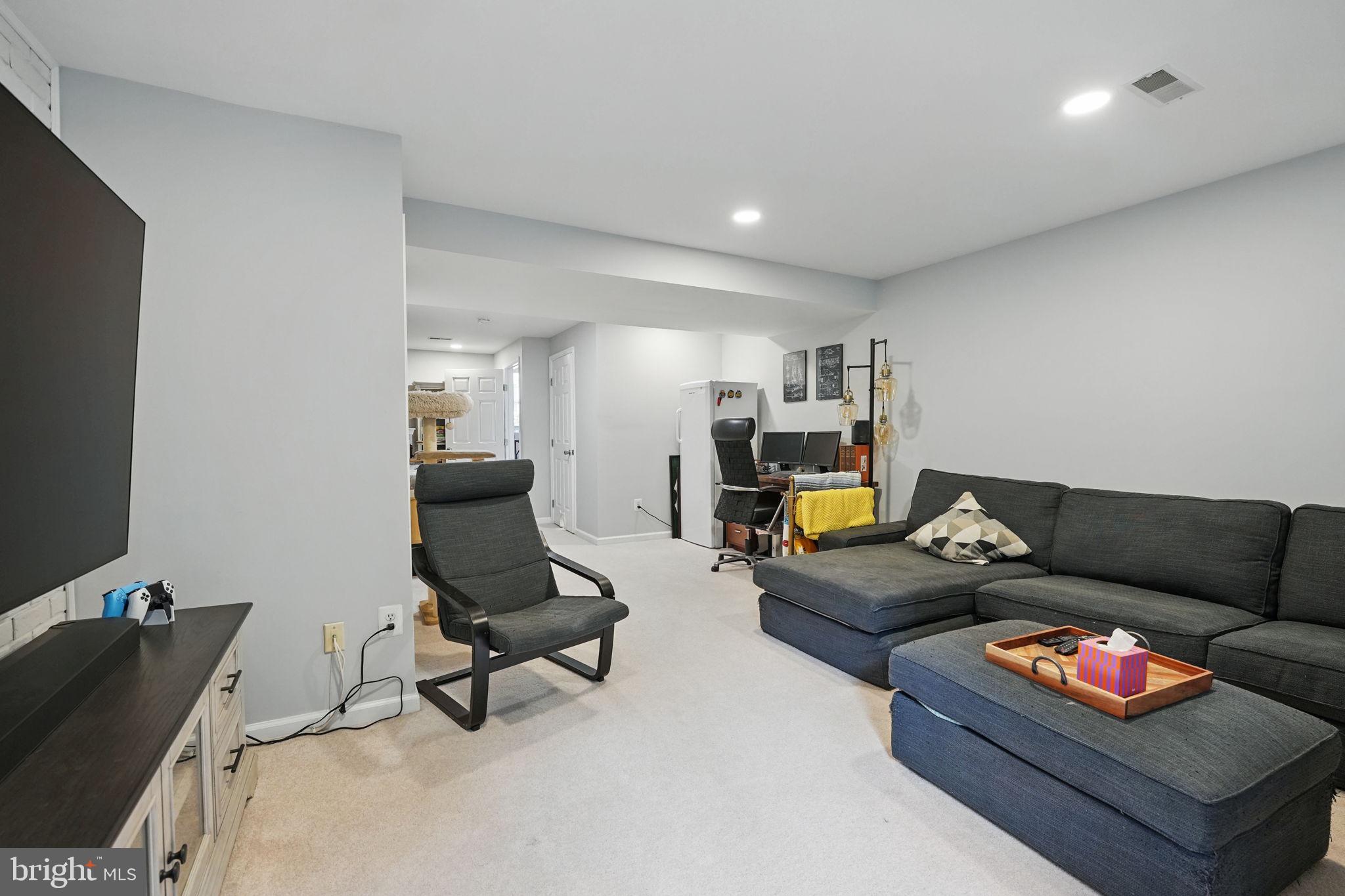 6383 Michael Robert Drive Springfield, VA 22150 - Photo 23 of 29 a living room with furniture and a flat screen tv