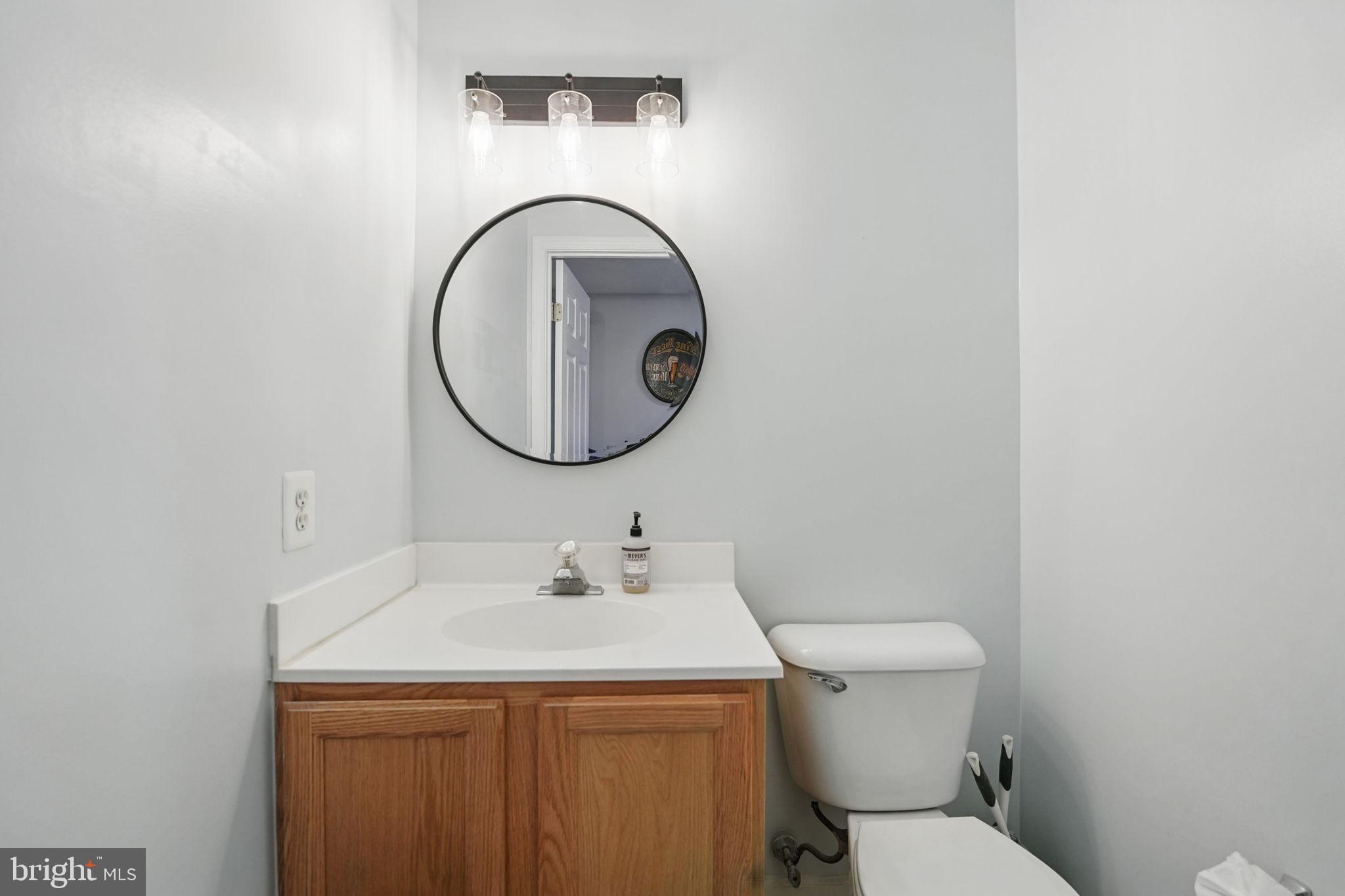 6383 Michael Robert Drive Springfield, VA 22150 - Photo 24 of 29 a bathroom with a sink a toilet and a mirror