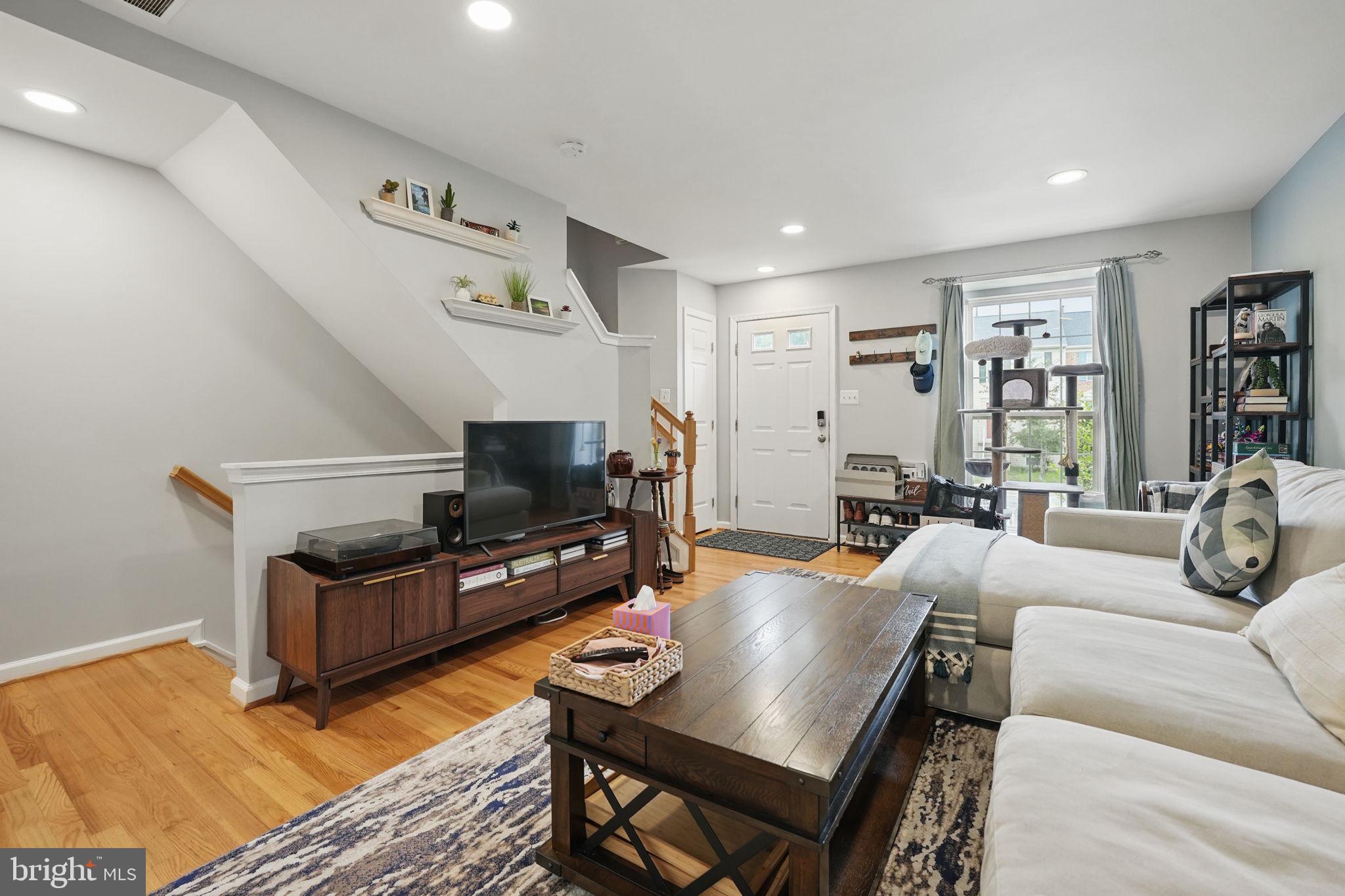 6383 Michael Robert Drive Springfield, VA 22150 - Photo 4 of 29 a living room with furniture and a flat screen tv