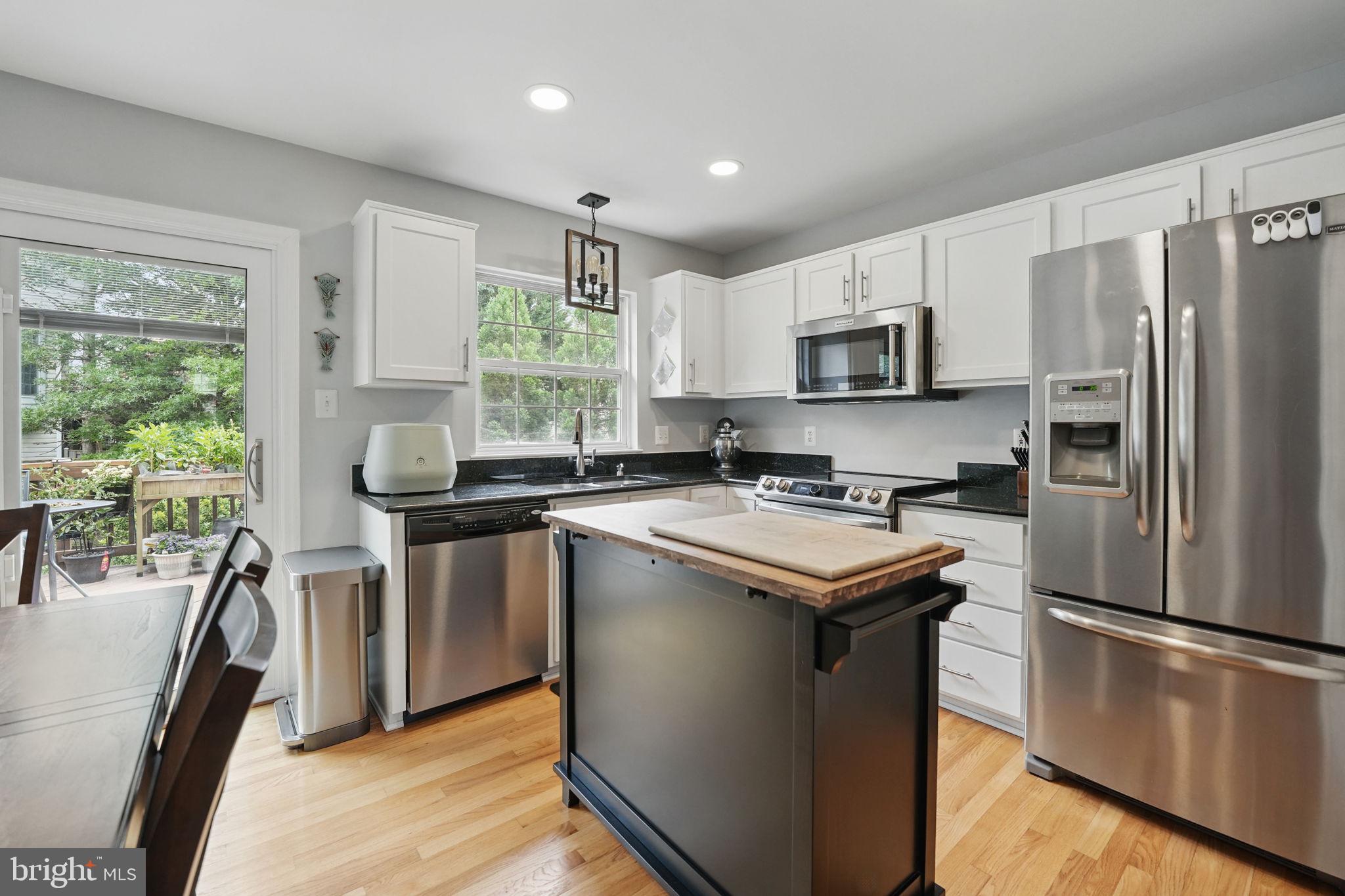 6383 Michael Robert Drive Springfield, VA 22150 - Photo 7 of 29 a kitchen with a stove a sink and a refrigerator
