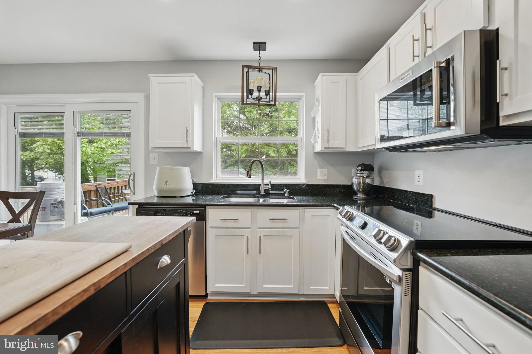 6383 Michael Robert Drive Springfield, VA 22150 - Photo 10 of 29 a kitchen with a stove a sink and a window