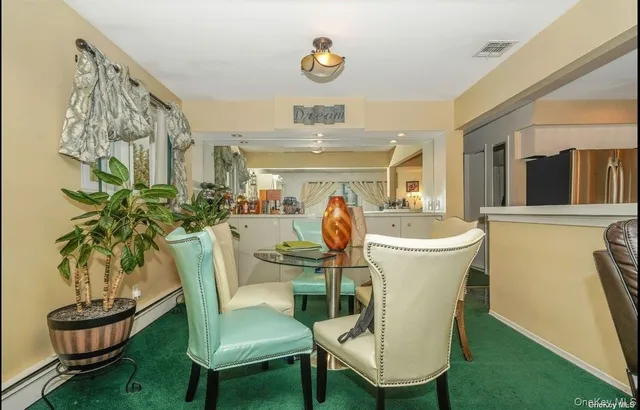 a living room with furniture a piano and a bookshelf