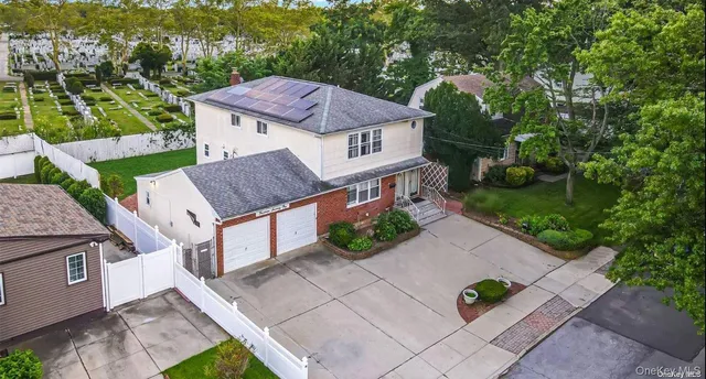 an aerial view of a house with table and chairs