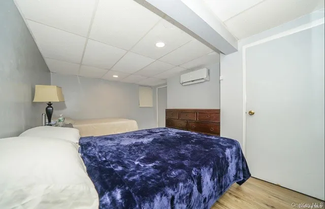 a spacious bedroom with a bed and a lamp on table