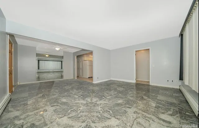 an empty room with closet and windows