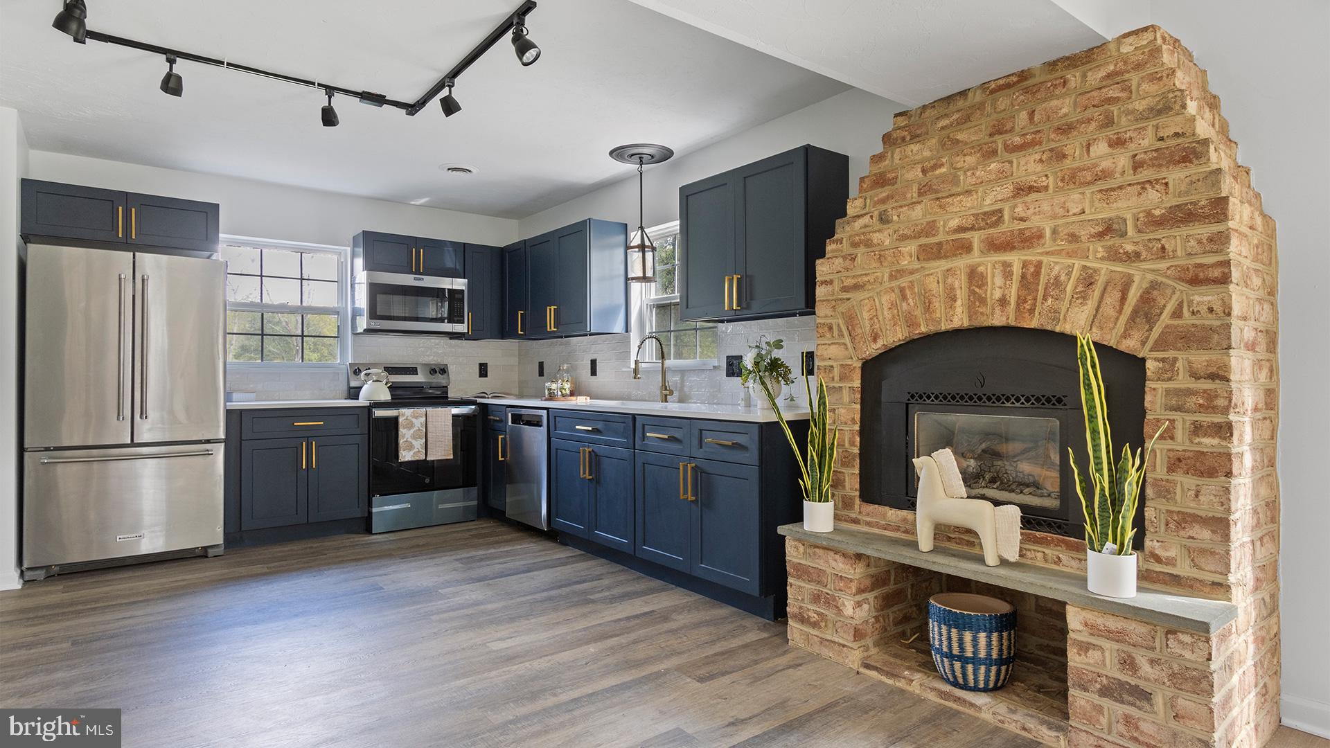 739 Company Farm Road Aspers, PA 17304 - Photo 11 of 45 a kitchen with stainless steel appliances granite countertop a refrigerator a stove and a wooden floors