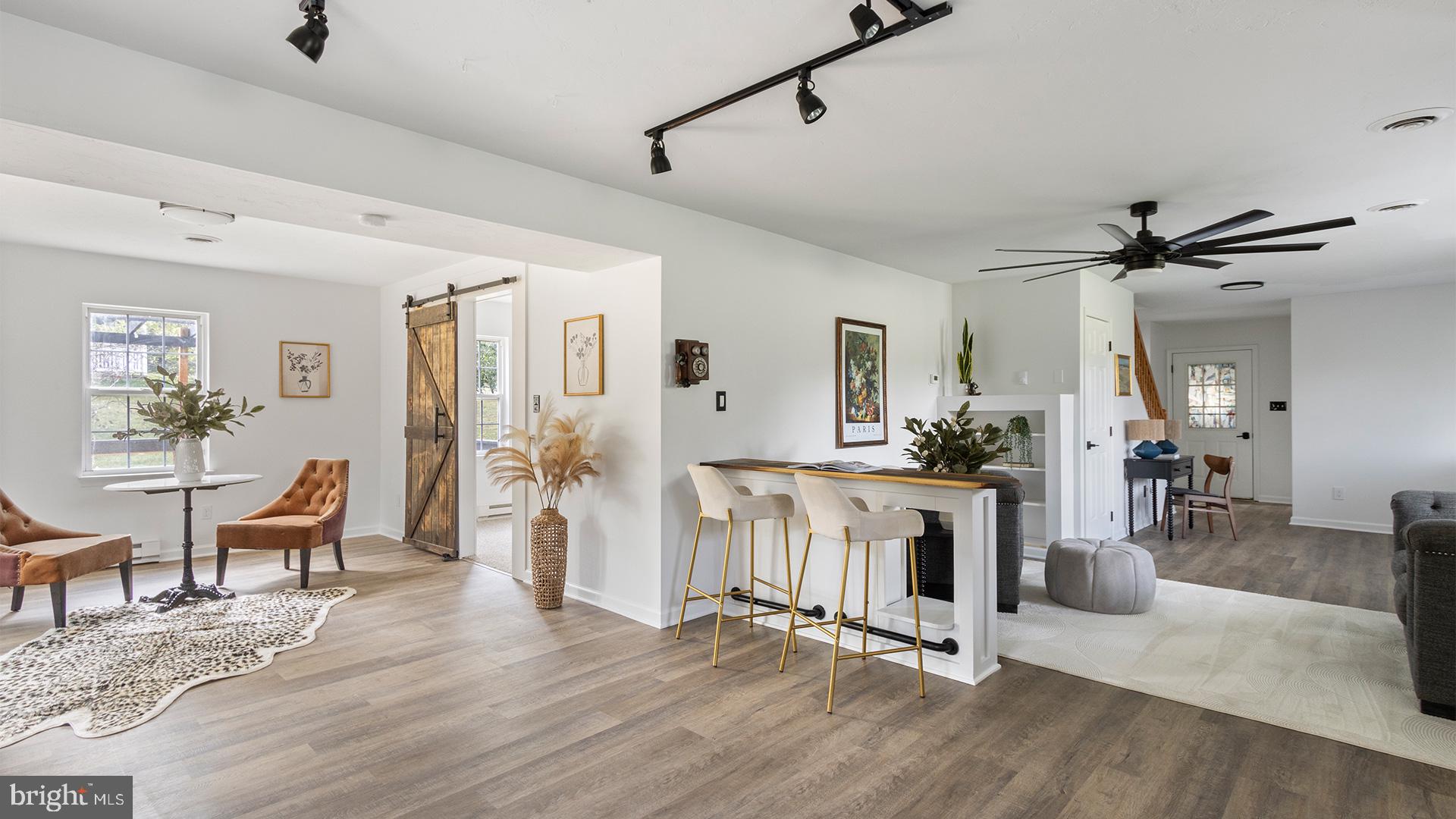 739 Company Farm Road Aspers, PA 17304 - Photo 14 of 45 a view of a livingroom with furniture a dinning area hardwood floor and a ceiling fan