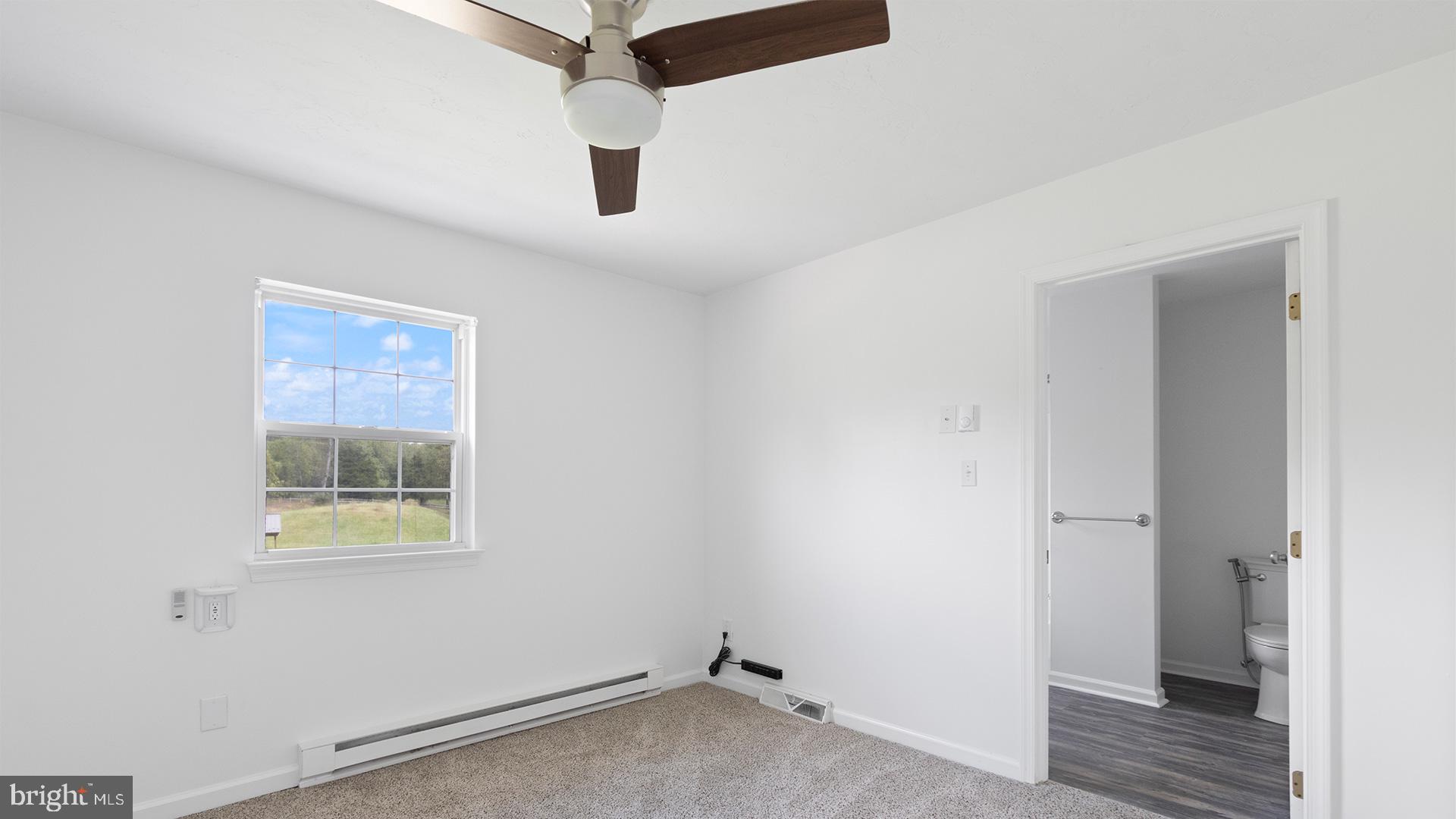 739 Company Farm Road Aspers, PA 17304 - Photo 38 of 45 an empty room with a window and a ceiling fan