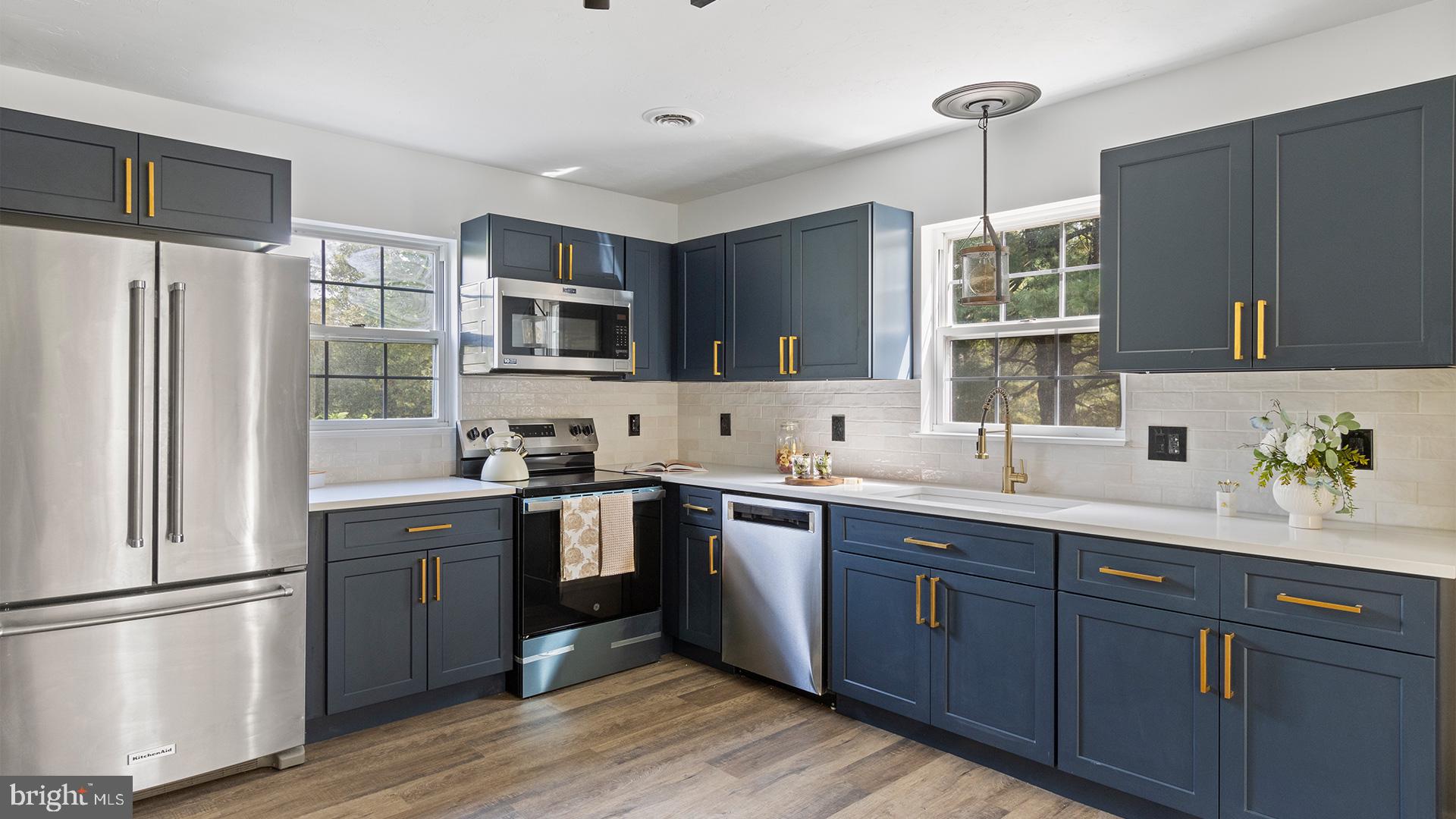 739 Company Farm Road Aspers, PA 17304 - Photo 9 of 45 a kitchen with a sink cabinets stainless steel appliances and a window