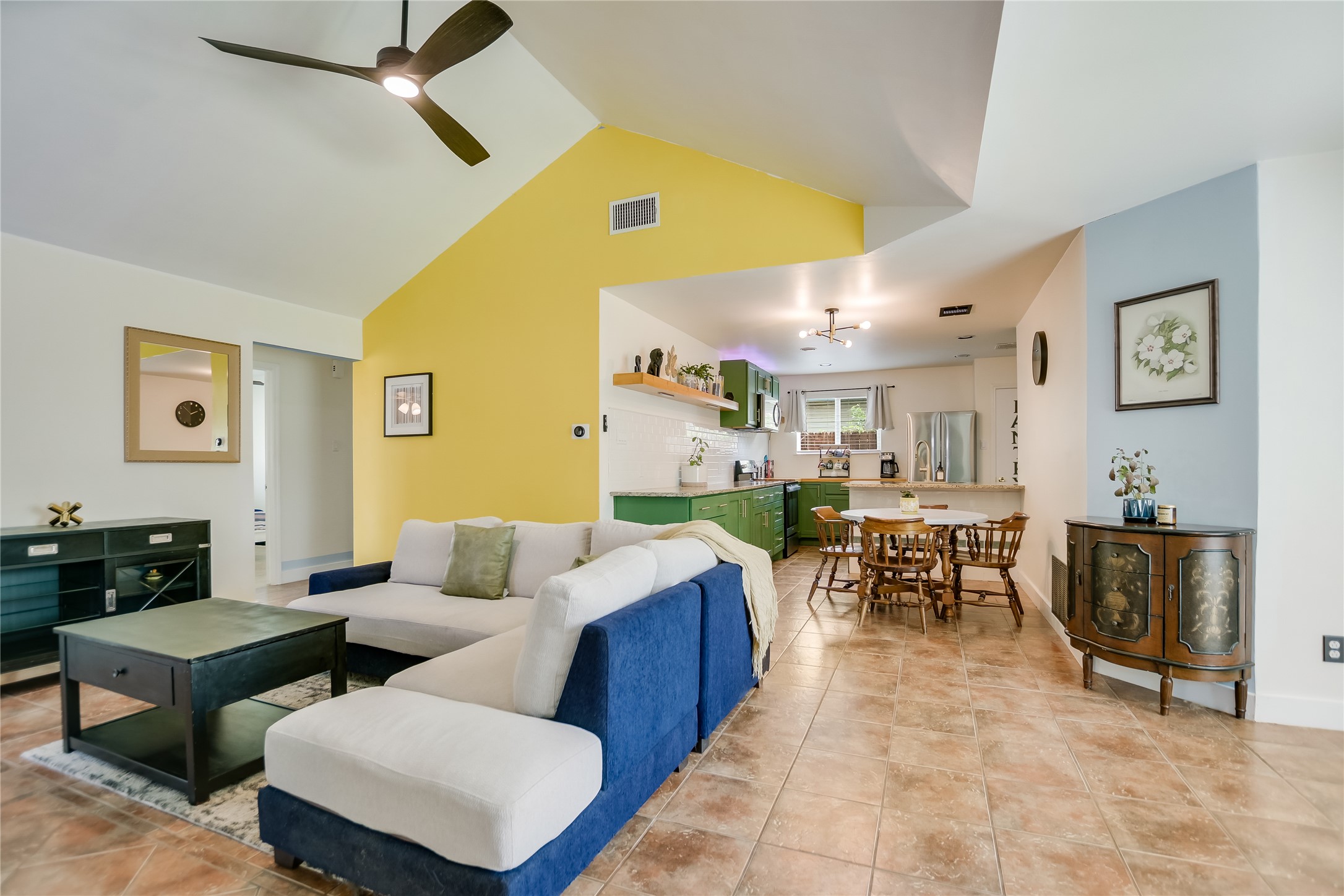 4702 Crest Oak Road Austin, TX 78744 - Photo 3 of 20 Open-concept living area with vaulted ceilings, contemporary ceiling fan, and large format tile flooring