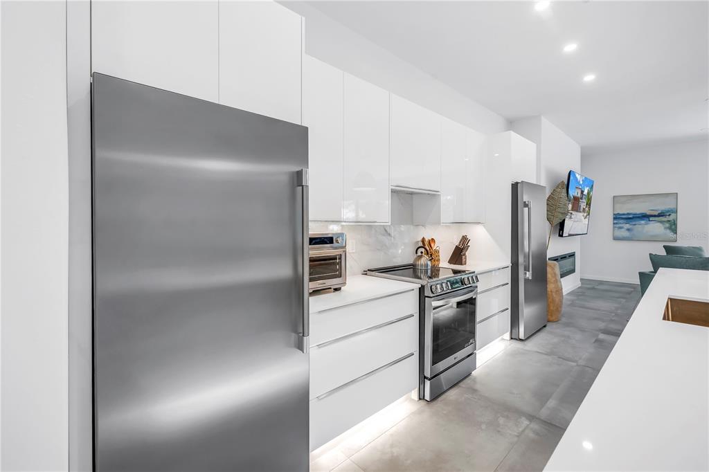 2314 Floyd Street Sarasota, FL 34239 - Photo 15 of 90 a kitchen with a refrigerator and white cabinets