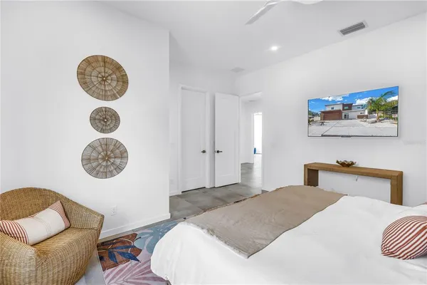 a patio with a table and chairs and potted plants
