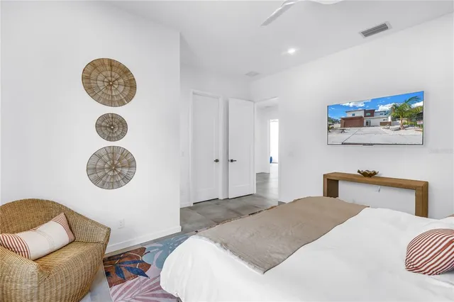 a patio with a table and chairs and potted plants