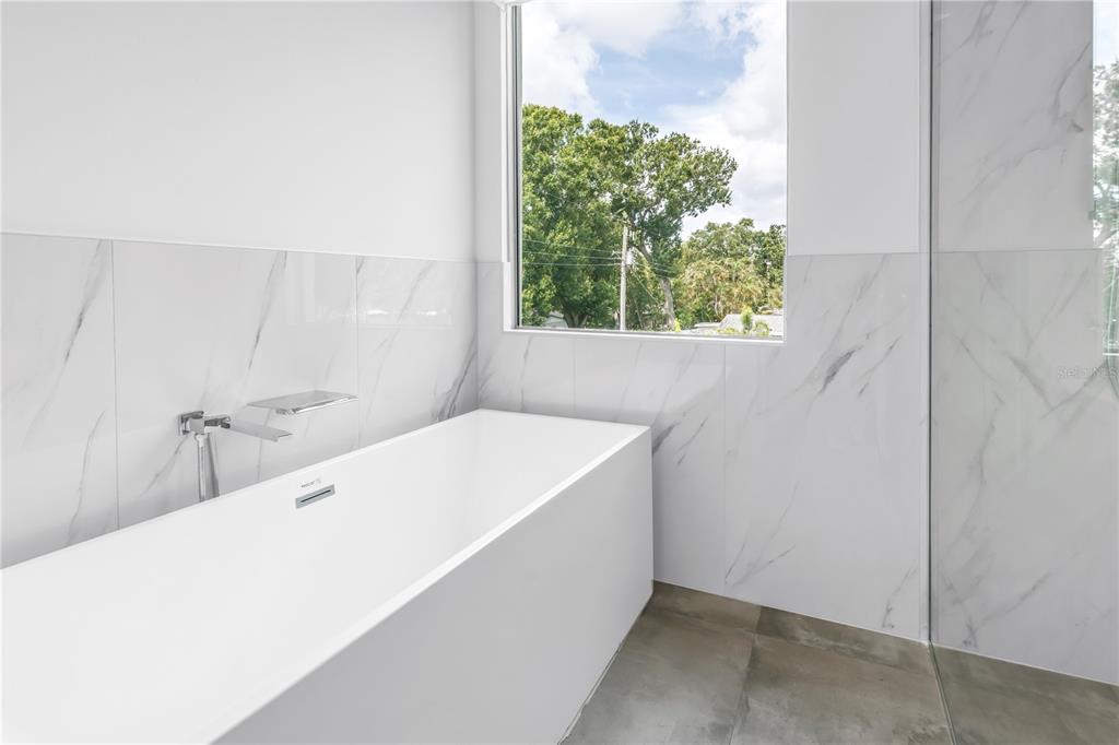 2314 Floyd Street Sarasota, FL 34239 - Photo 45 of 90 a bathroom with a tub sink and window