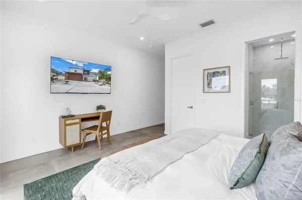 a roof deck with couches and potted plants