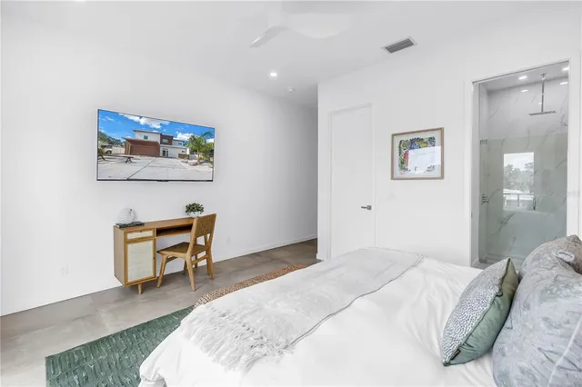 a roof deck with couches and potted plants