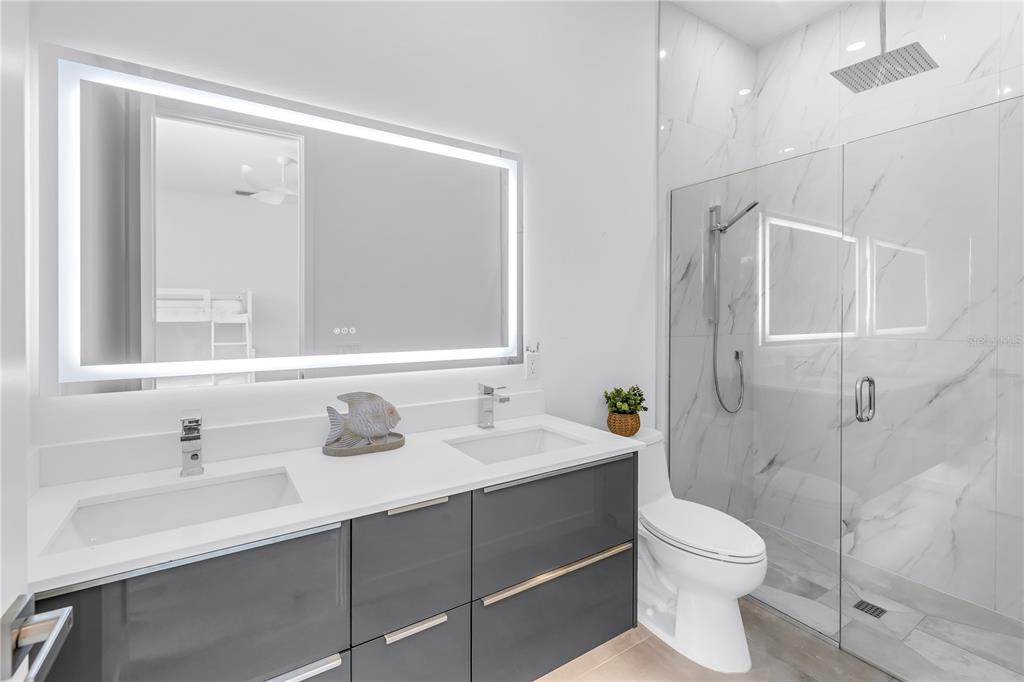 2314 Floyd Street Sarasota, FL 34239 - Photo 54 of 90 a bathroom with a sink toilet a mirror and shower