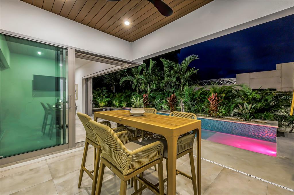 2314 Floyd Street Sarasota, FL 34239 - Photo 62 of 90 a table and chairs with potted plants