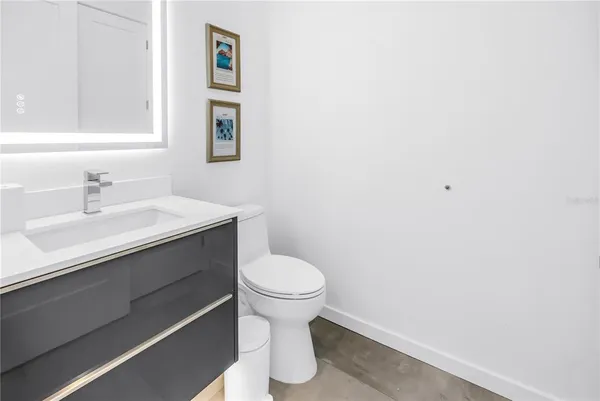 a kitchen with a refrigerator and white cabinets