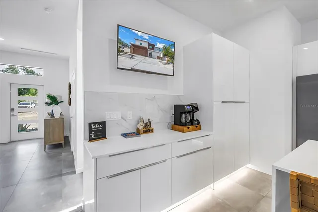 a kitchen with stainless steel appliances granite countertop a refrigerator and a stove